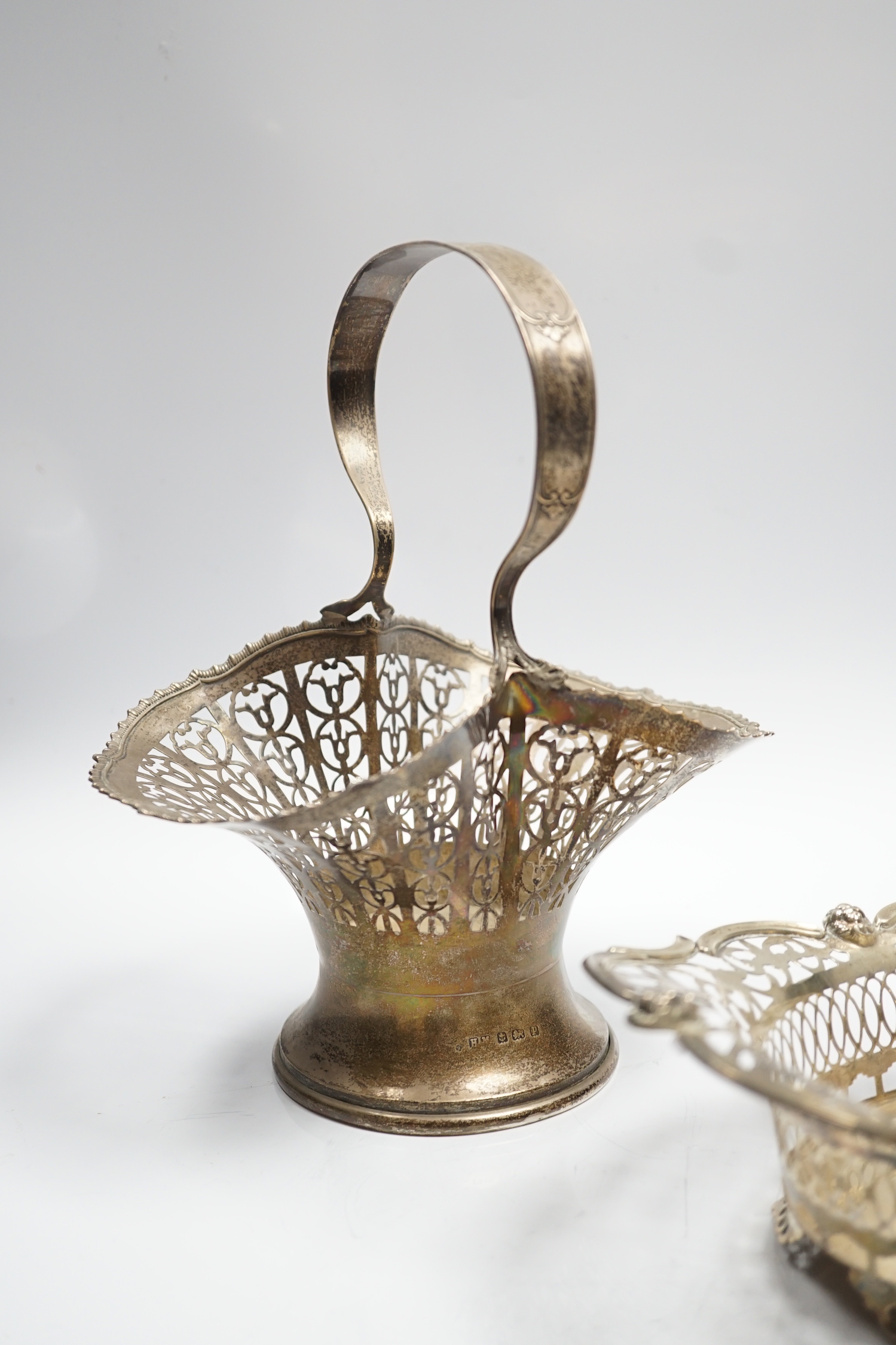 A George V pierced silver basket, Henry Matthews, Birmingham, 1914, height 23.7cm, together with a pierced silver oval dish, London, 1912, 14.1oz.